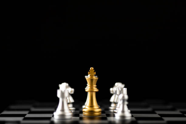 istock The golden chess pieces are surrounded by silver pawns. 2158270071