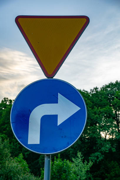 Germany, Berlin, Zehlendorf, April 14, 2024 - Yellow curved arrow on a road