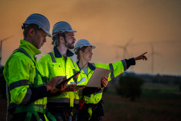istock Team Engineers men and woman checking and inspecting on construction with sunset sky. people operation. Wind turbine for electrical of clean energy and environment. Industrial of sustainable. 2158272830