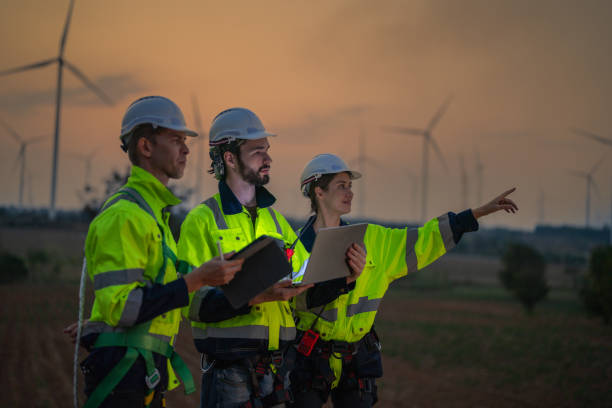 istock Team Engineers men and woman checking and inspecting on construction with sunset sky. people operation. Wind turbine for electrical of clean energy and environment. Industrial of sustainable. 2158272944