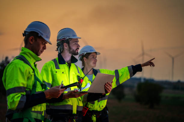 istock Team Engineers men and woman checking and inspecting on construction with sunset sky. people operation. Wind turbine for electrical of clean energy and environment. Industrial of sustainable. 2158273326