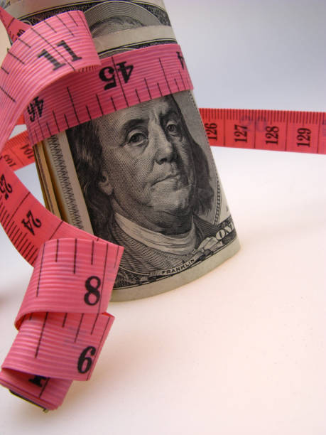 istock A hundred -dollar bill is twisted by a measuring meter. 2158273452