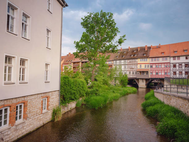 Erfurt, Germany - May 21, 2023: ancient houses on the banks of the Gera River in city center, historical heritage.