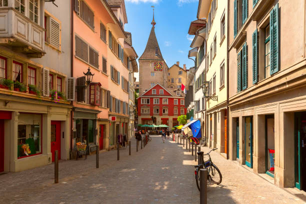 Street in Old Town Zurich, Switzerland Charming street in old town of Zurich, Switzerland, featuring colorful buildings and clock tower historic-district stock pictures, royalty-free photos & images