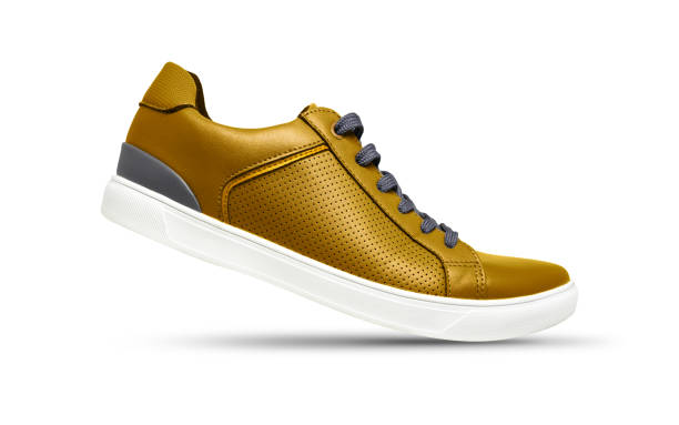 golden sneakers isolated on white background with shadow