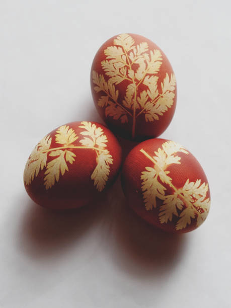istock Red eggs adorned with detailed yellow foliage designs. 2158276875