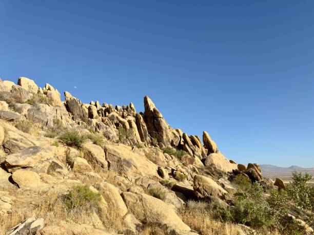 istock Large boulders and rocks dominate a rugged mountain desert landscape, creating a dramatic and stark scene of natural beauty, resilience, and timelessness against a backdrop of arid terrain. 2158277717