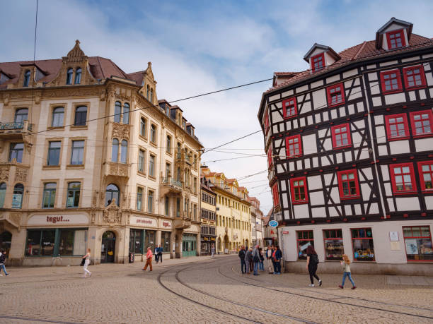 Erfurt, Germany - May 21, 2023: A lively town square with a famous cathedral and monuments, where fairs and other events take place.