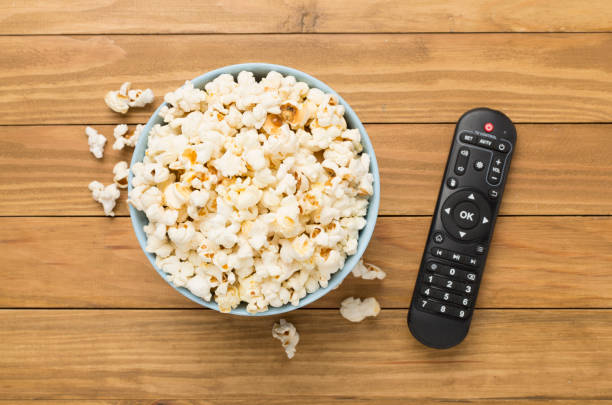 istock Popcorn and TV remote controller on wooden background 2158279649