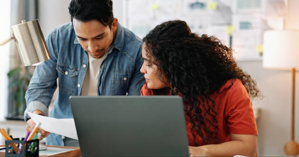 istock People, creative and business or talking with laptop, partners and paperwork discussion for small agency. Documents, contract and sales review or brainstorming project, collaboration and work meeting 2158279964