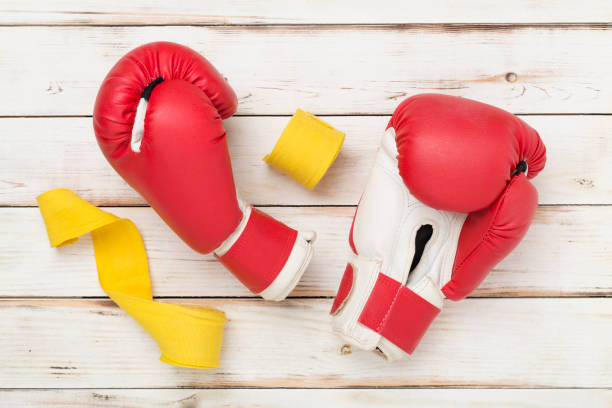 istock Red boxing gloves on wooden background, top view. 2158280205