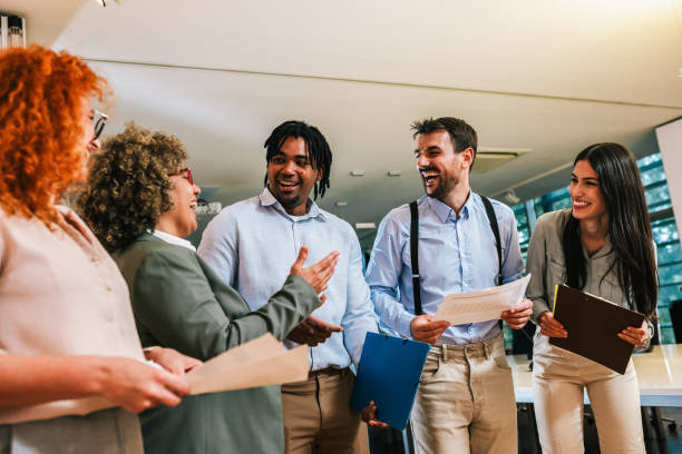 istock Multiracial group of colleagues walking down the hall and talk about work. 2158280334