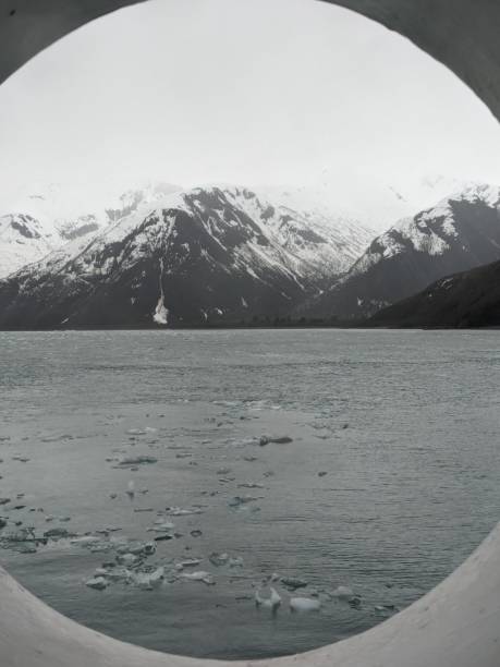 istock Mountains with snow and ice in water through porthole 2158280458