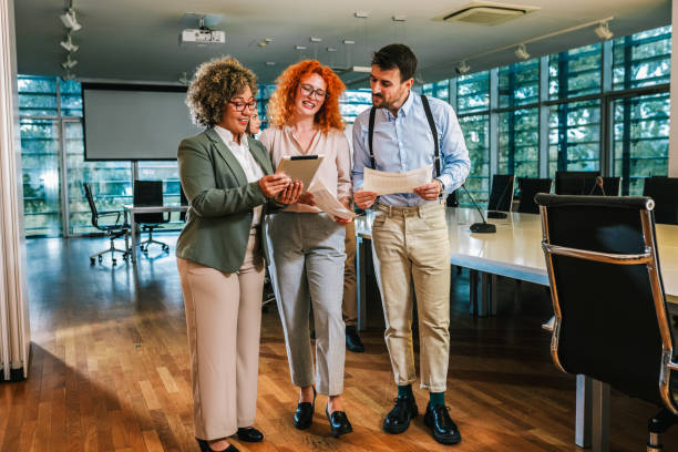 istock Three multiracial colleagues talk about work and look at tablet. 2158280535