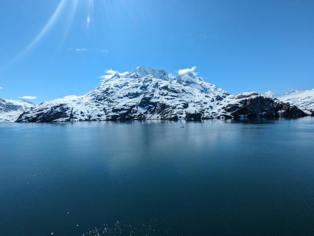 istock Snowy mountain by water 2158280543