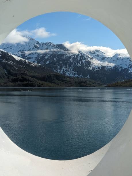 istock Porthole view of snowy mountain 2158280579