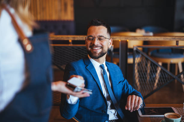 istock Cheerful Businessman Making Payment with Card at Cafeteria 2158285023