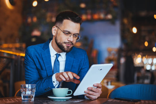 istock Focused Businessman with Tablet at Coffee Shop 2158285031