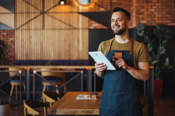 istock Smiling Caucasian Waiter Holding Tablet in Modern Eatery 2158285114