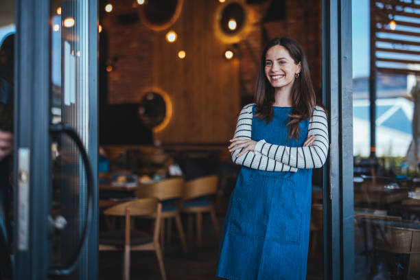 istock Friendly Female Barista Ready to Serve in Chic Cafe 2158285119