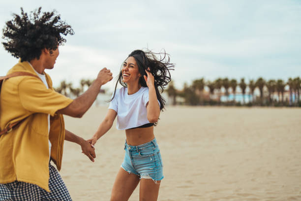 istock Joyful Hispanic Couple Enjoying Beachside Fun 2158285255