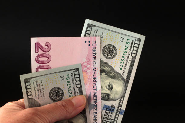 istock A hand is holding Turkish and US Dollars Banknotes 2158285713