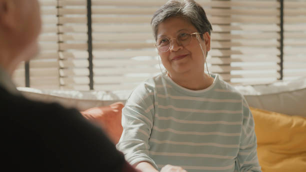 istock old senior elder wife woman try to support encourage her husband while try to make a smile on her face happiness joyful asian old retired couple healthy insurance lifestyle at home 2158285764