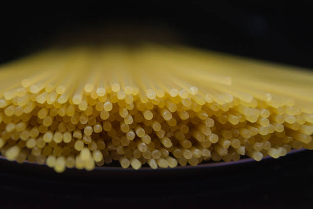 Raw spaghetti ends close-up macro background.