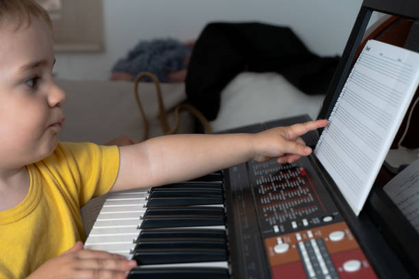 istock child learning to play the piano 2158290433