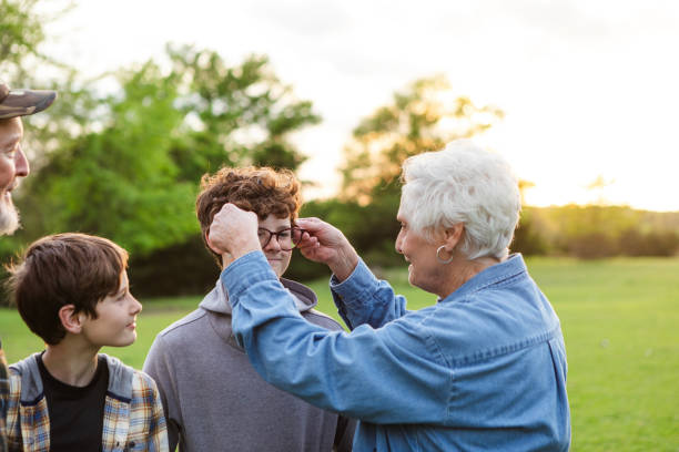 Joyful bride bows respectfully to her elderly parents to receive their advice on married life before her wedding ceremony.