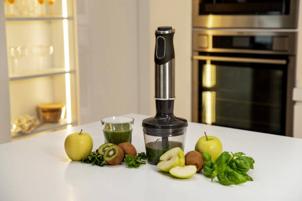 istock Cordless immersion blender with green fresh fruits on a modern kitchen 2158293685