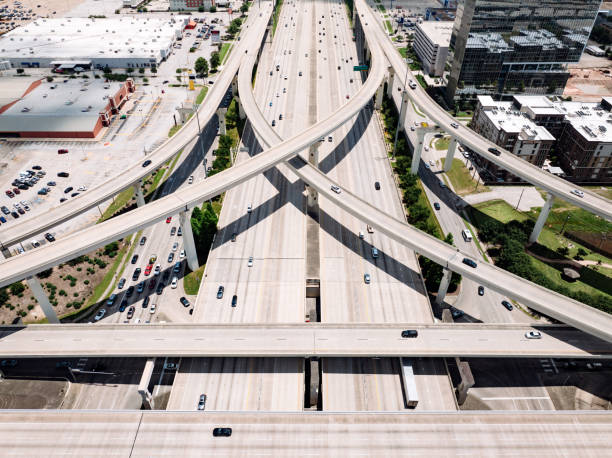 Drone point of view of traffic on the interstate, intertwining on ramps and off ramps.