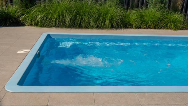 istock In the home pool, the counter-current system is turned on, making it an excellent place to swim in the backyard 2158295780