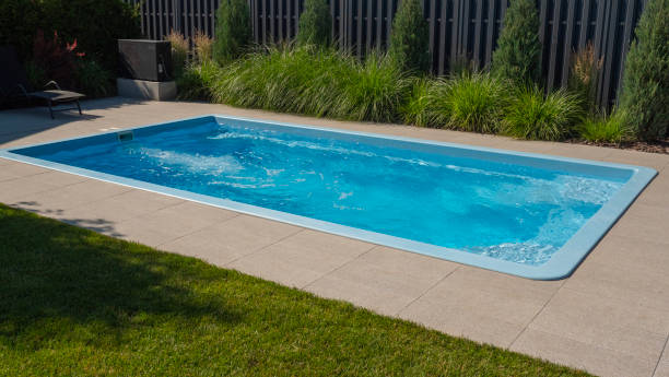 istock In the home pool, the counter-current system is turned on, making it an excellent place to swim in the backyard 2158295833