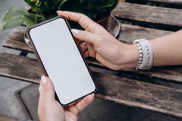istock Mockup woman's hand holding using smart phone with white blank screen at coffee shop, mobile app design and advertising, online marketing 2158296221