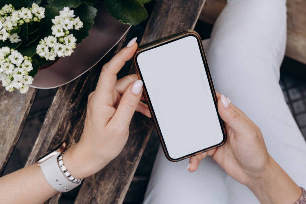 istock Mockup woman's hand holding using smart phone with white blank screen at coffee shop, mobile app design and advertising, online marketing 2158296224