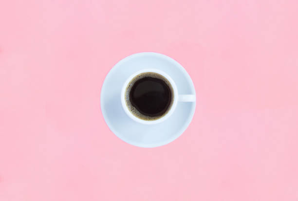 istock Black coffee in the white cup on the pink background. Copy space. Top view. 2158297502
