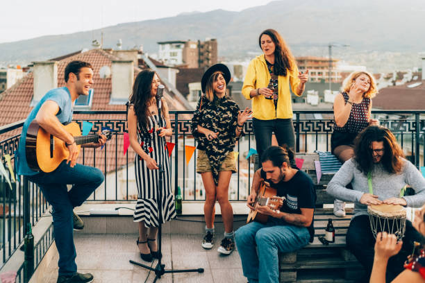 istock Friends drinking and partying on the rooftop 2158298718