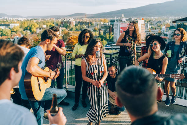 istock Friends drinking and partying on the rooftop 2158299011