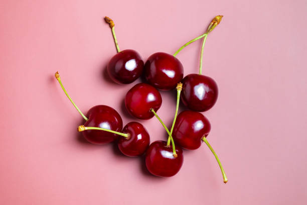 istock Sweet juicy cherries on a pink background 2158302553