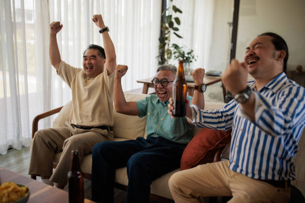 istock Men Enjoying Beer and Match 2158302626