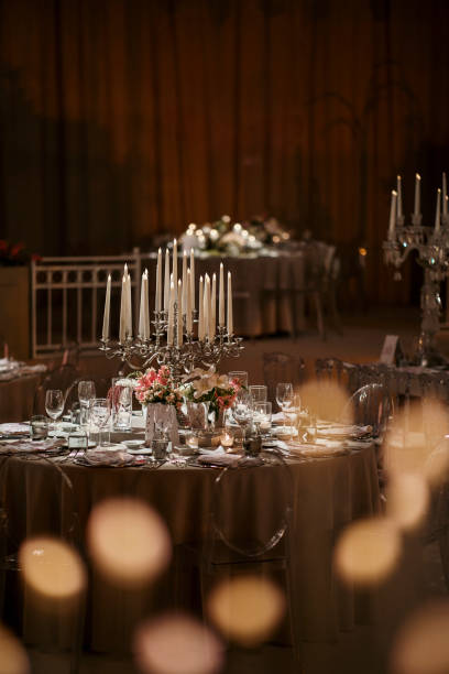istock Beautiful table setting for family Christmas dinner. Cozy atmosphere, candlelight on tall candelabras. stock photo 2158305550