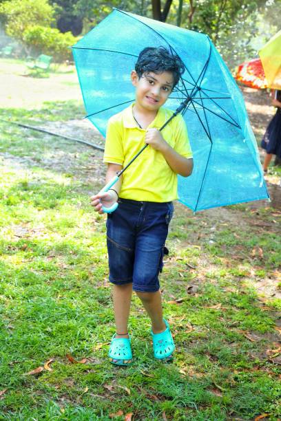 istock Kids enjoying rainy season 2158306855