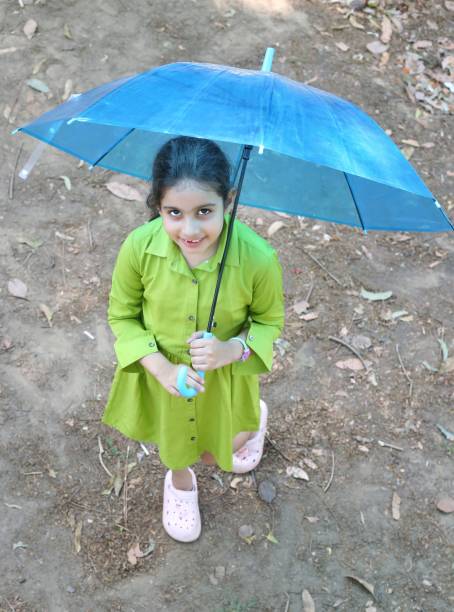 istock Kids enjoying rainy season 2158308562