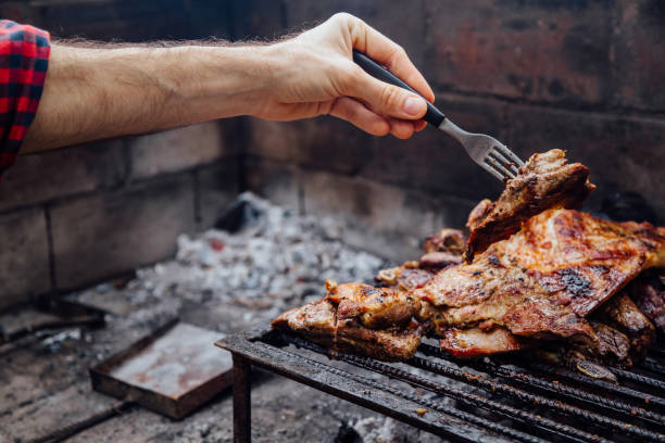 istock Young man doing a bbq. Traditional Asado of Argentina. 2158315331