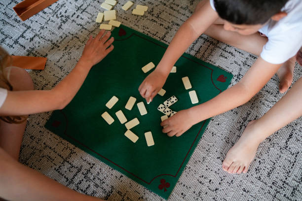 istock Two children playing a game of dominoes 2158317766