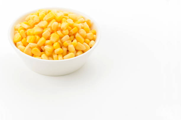 Canned sweet corn in a white bowl on white background