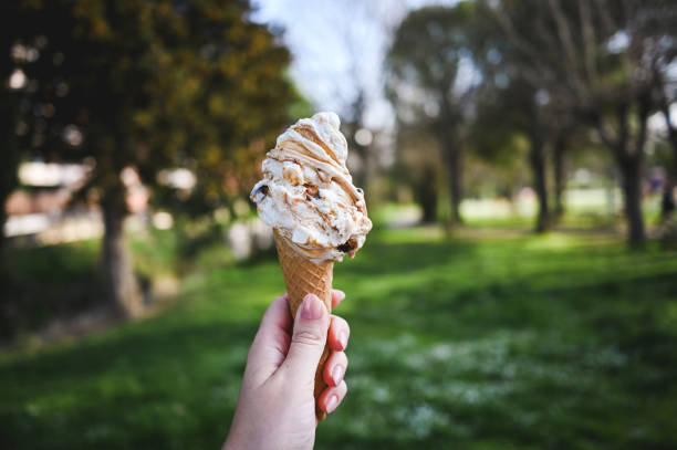 istock Caramel ice cream in a hand. 2158320278