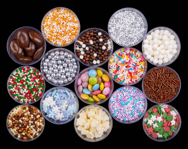 Colorful sugar and chocolate sprinkles, nonpareils in plastic cups, from above