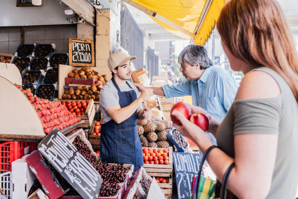 istock Young seller assisting customer at the grocery store 2158321612